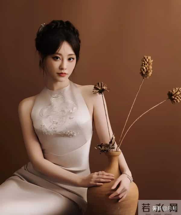 祝绪丹，身穿紧身拖尾旗袍礼服，端庄大方