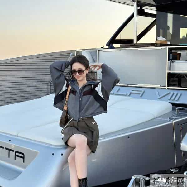游艇上，刘亦菲短款撞色外套利落飒爽，搭配工装风短裙与复古靴