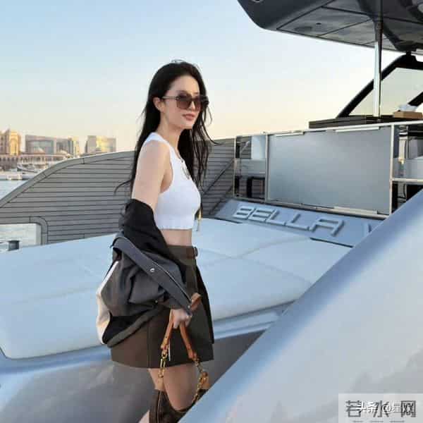 游艇上，刘亦菲短款撞色外套利落飒爽，搭配工装风短裙与复古靴