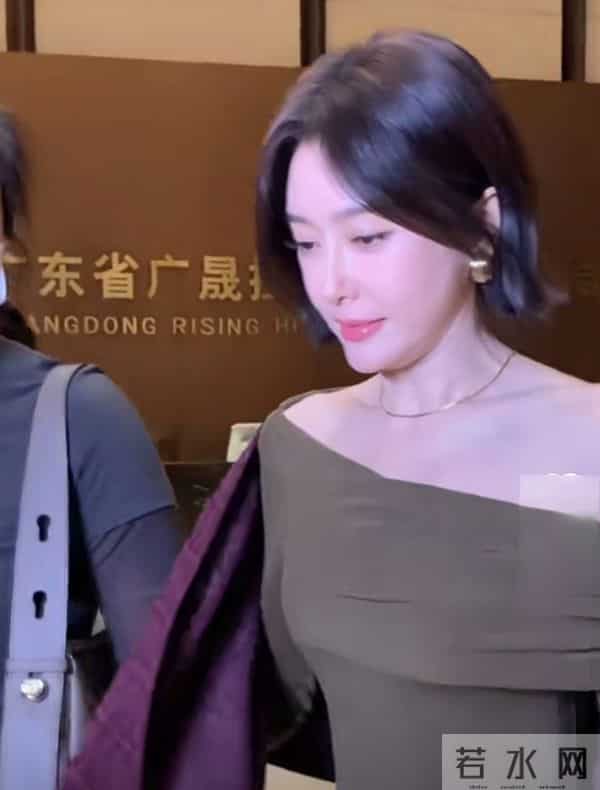 秦岚抵达广州出席活动，墨绿长裙搭酒红披巾，短发超有韵味